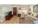 Comfortable living room with wood floors, a brown wooden door, and simple decor at 459 S Boojum Way, Mesa, AZ 85208