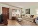 Inviting living room featuring a sofa, patterned rug, and a wooden front door at 459 S Boojum Way, Mesa, AZ 85208