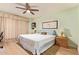 Bright main bedroom with a ceiling fan, light-green walls, and views of an expansive window at 459 S Boojum Way, Mesa, AZ 85208