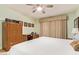 Bright main bedroom features a ceiling fan, expansive window, and wood-look flooring at 459 S Boojum Way, Mesa, AZ 85208