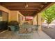 Cozy covered patio with an outdoor dining area and grill, perfect for outdoor entertaining at 459 S Boojum Way, Mesa, AZ 85208