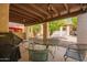 Inviting covered patio with wrought iron furniture, offering a perfect outdoor dining and relaxation space at 459 S Boojum Way, Mesa, AZ 85208