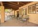 Spacious covered patio featuring a dining set and relaxing chairs, perfect for enjoying the outdoors at 459 S Boojum Way, Mesa, AZ 85208
