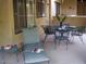 Charming patio area with comfortable seating, a table set for tea, and garden views at 459 S Boojum Way, Mesa, AZ 85208