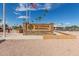 Stone Veterans Memorial sign with the American flag waving in the breeze at 459 S Boojum Way, Mesa, AZ 85208
