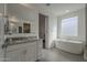 Bathroom featuring a granite countertop, tub, glass shower, and view of the bedroom at 4878 W Elijah Ln, San Tan Valley, AZ 85144