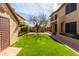 Spacious backyard showcases well-manicured lawn and mature shade tree in a fenced yard at 4946 W Evans Dr, Glendale, AZ 85306