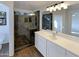 Modern bathroom with a glass-enclosed shower and a white double vanity at 517 S 125Th Ave, Avondale, AZ 85323