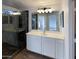 Bright bathroom with double vanity, walk-in shower with glass doors, and neutral color palette at 517 S 125Th Ave, Avondale, AZ 85323