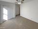 Cozy bedroom with carpet, closet, ceiling fan, and white walls, offering a serene and inviting atmosphere at 517 S 125Th Ave, Avondale, AZ 85323