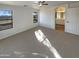 Bright, empty bedroom with neutral carpet, and a view to the ensuite bathroom at 517 S 125Th Ave, Avondale, AZ 85323