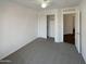 Neutral bedroom with carpet, closet, white walls, and a ceiling fan, creating a comfortable living space at 517 S 125Th Ave, Avondale, AZ 85323
