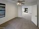 Bedroom with view to other rooms through double doors, large window and neutral carpet at 517 S 125Th Ave, Avondale, AZ 85323