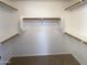 Walk-in closet with built-in shelving and ample storage space at 517 S 125Th Ave, Avondale, AZ 85323
