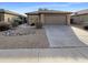 Charming single-story home with a low maintenance rock landscape, a two car garage, and tile roof at 517 S 125Th Ave, Avondale, AZ 85323