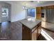 Eat-in Kitchen with a large island, stainless appliances and wood-look floors at 517 S 125Th Ave, Avondale, AZ 85323
