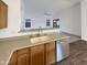 Kitchen view showcasing a stainless steel dishwasher and a sink with granite countertops at 517 S 125Th Ave, Avondale, AZ 85323