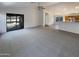 Open-concept living space with sliding glass doors, and a partial view to the kitchen area at 517 S 125Th Ave, Avondale, AZ 85323