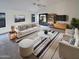Bright, open living room with modern furnishings, ceiling fan, and sliding glass doors to the backyard patio at 517 S 125Th Ave, Avondale, AZ 85323