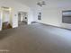 Expansive living room with neutral carpeting and abundant natural light from windows at 517 S 125Th Ave, Avondale, AZ 85323