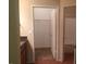 Bathroom with a walk-in closet, granite countertop, cherry wood cabinets, and a large mirror at 5335 E Shea Blvd # 1095, Scottsdale, AZ 85254