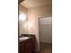 Bathroom featuring granite countertops, cherry wood cabinets, a large mirror, and a walk-in closet at 5335 E Shea Blvd # 1095, Scottsdale, AZ 85254