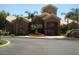 Inviting clubhouse featuring a unique architectural design, lush landscaping, and a charming fountain at 5335 E Shea Blvd # 1095, Scottsdale, AZ 85254