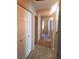 Long hallway featuring white walls and doors, neutral carpeting, and overhead lighting at 5335 E Shea Blvd # 1095, Scottsdale, AZ 85254
