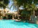Stunning pool area with a cozy cabana for shade, surrounded by lush palm trees and greenery at 5335 E Shea Blvd # 1095, Scottsdale, AZ 85254