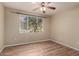 Bright bedroom with ceiling fan, wood-look floors, and large window for natural light at 5345 E Van Buren St # 167, Phoenix, AZ 85008