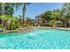 Lush community pool area with fountains, palm trees, and lounge chairs at 5345 E Van Buren St # 167, Phoenix, AZ 85008