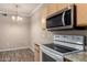 Well-lit kitchen featuring stainless steel microwave, white appliances, and granite countertops at 5345 E Van Buren St # 167, Phoenix, AZ 85008