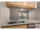 Modern kitchen featuring granite countertops, stainless steel appliances, and light wood cabinetry at 5345 E Van Buren St # 167, Phoenix, AZ 85008