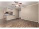 Inviting living room featuring wood floors and modern ceiling fan, seamlessly connecting to the kitchen at 5345 E Van Buren St # 167, Phoenix, AZ 85008