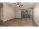 Spacious living room featuring ceiling fan, wood-look floors, and sliding glass doors to the patio at 5345 E Van Buren St # 167, Phoenix, AZ 85008