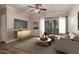 Staged living room with a modern entertainment center, comfortable seating, and natural light at 5345 E Van Buren St # 167, Phoenix, AZ 85008