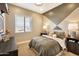 Modern bedroom featuring neutral tones, a patterned accent wall and dark wood furniture at 5719 S Quartz St, Gilbert, AZ 85298