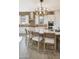 Elegant kitchen boasts a large island with counter seating, designer lighting, and stainless steel appliances at 5719 S Quartz St, Gilbert, AZ 85298