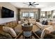 Spacious living room showcasing a comfortable sectional sofa, accent chairs, and a decorative coffee table on a neutral rug at 5719 S Quartz St, Gilbert, AZ 85298