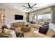 Inviting living room with a large sofa, decorative pillows, modern furniture, and ample natural light through large windows at 5719 S Quartz St, Gilbert, AZ 85298
