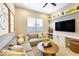 Comfortable living room featuring a large sectional couch, built-in media center and a ceiling fan at 5719 S Quartz St, Gilbert, AZ 85298