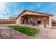 Well-maintained backyard with artificial grass, brick pavers, and a covered patio for relaxation and entertainment at 6965 E Hacienda La Noria Ln, Gold Canyon, AZ 85118