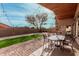 Inviting backyard patio featuring brick pavers, artificial grass, and string lights for outdoor entertaining at 6965 E Hacienda La Noria Ln, Gold Canyon, AZ 85118