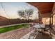 Inviting backyard patio with string lights, green grass, and beautiful outdoor furniture at 6965 E Hacienda La Noria Ln, Gold Canyon, AZ 85118