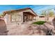Expansive backyard featuring desert landscaping, a covered patio, and a paved walkway for outdoor enjoyment at 6965 E Hacienda La Noria Ln, Gold Canyon, AZ 85118