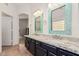 Stylish bathroom offers double sinks, granite counters, and decorative mirrors for elegance at 6965 E Hacienda La Noria Ln, Gold Canyon, AZ 85118