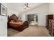 Spacious bedroom with ceiling fan, sliding glass doors, and plush carpeting for comfort at 6965 E Hacienda La Noria Ln, Gold Canyon, AZ 85118