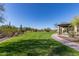 Lush green community park with desert landscaping, a walking path, and a shaded picnic area for residents to enjoy at 6965 E Hacienda La Noria Ln, Gold Canyon, AZ 85118