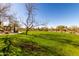 Lush green community park with mature trees, desert landscaping, and walking paths for outdoor recreation at 6965 E Hacienda La Noria Ln, Gold Canyon, AZ 85118
