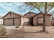 Charming single-story home showcasing a spacious two-car garage and desert landscaping at 6965 E Hacienda La Noria Ln, Gold Canyon, AZ 85118